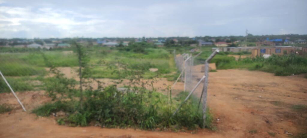 A vast piece of land fenced off by land barons, restricting access and sparking disputes over illegal land grabs and ownership in the area.